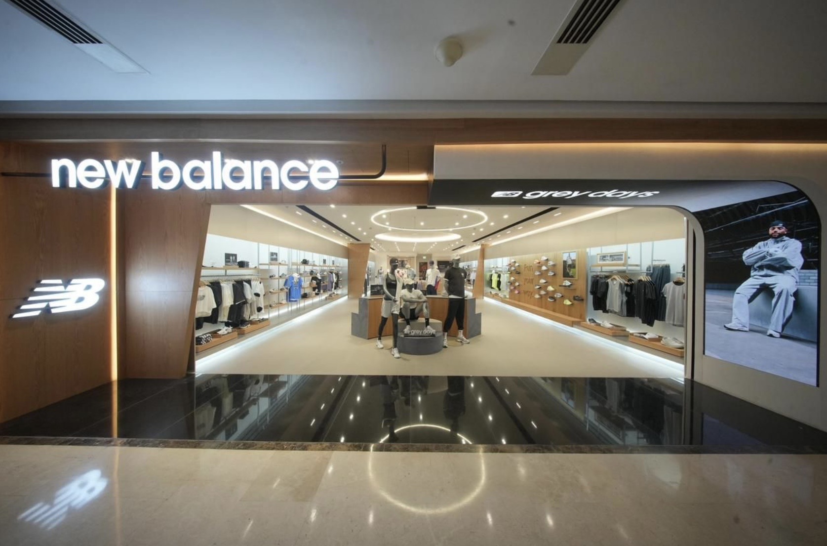 New Balance storefront with illuminated signage and Grey Days campaign