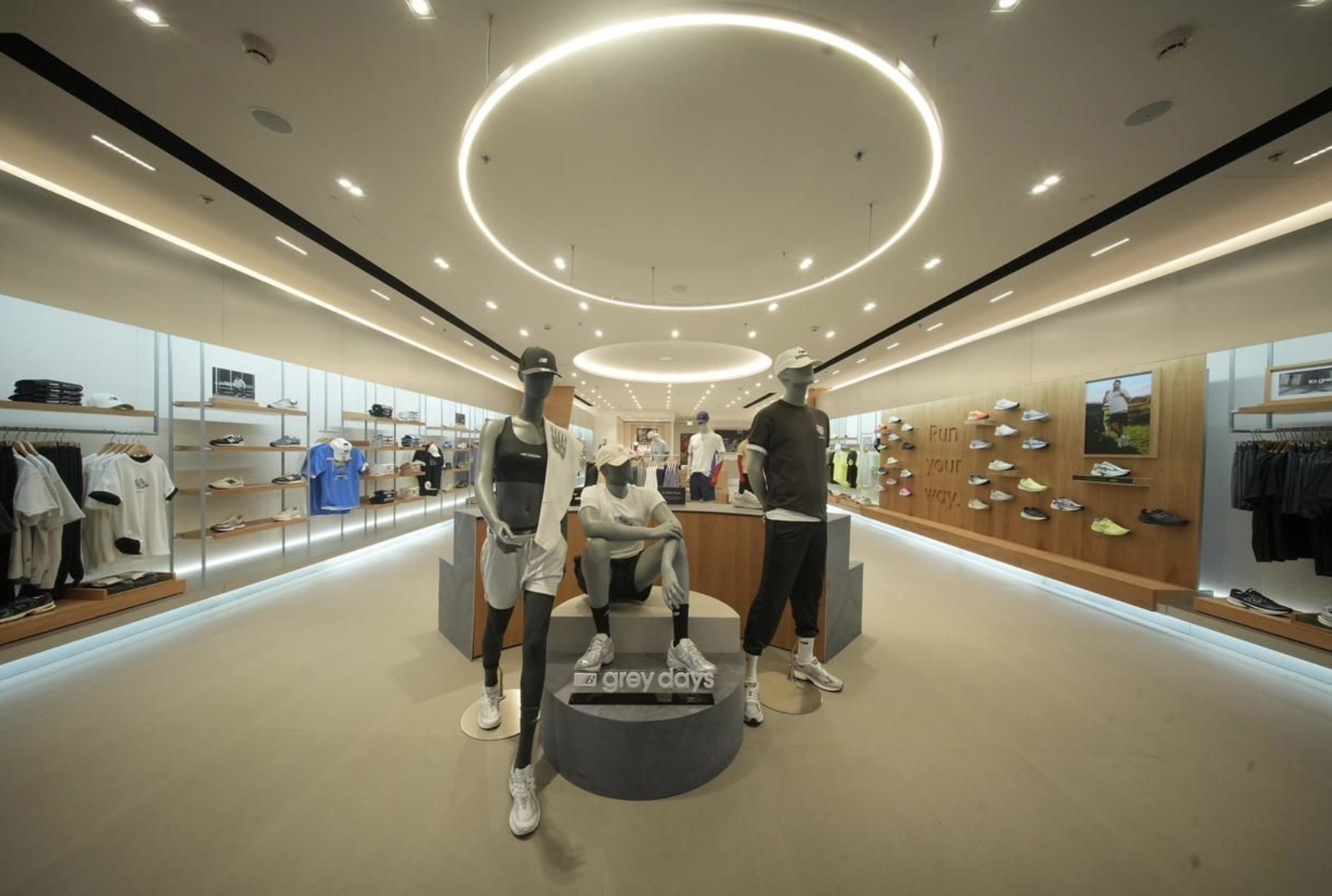 Interior of New Balance store with concentric ring fixture and mannequin display
