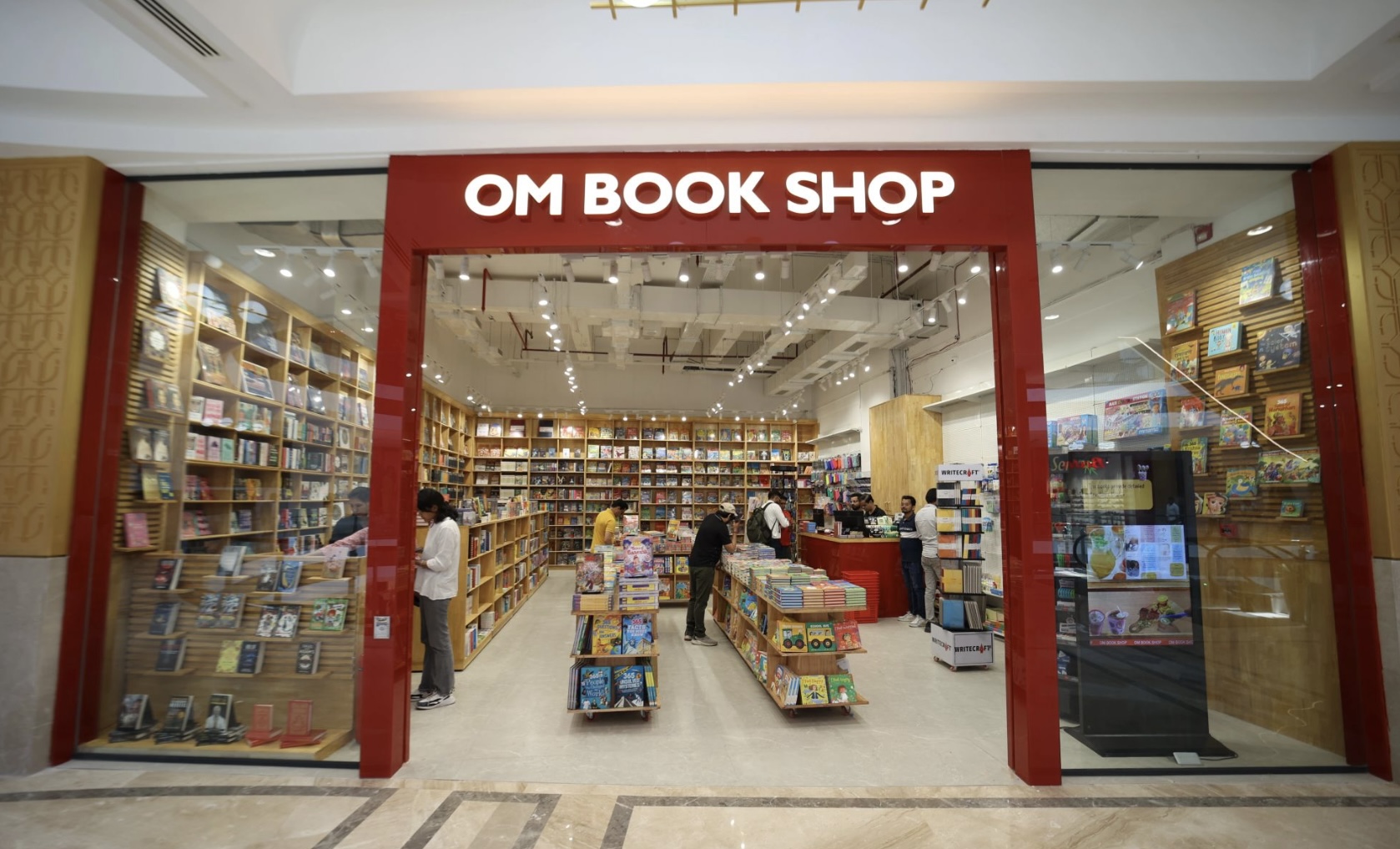 Om Book Shop storefront with red frame entrance