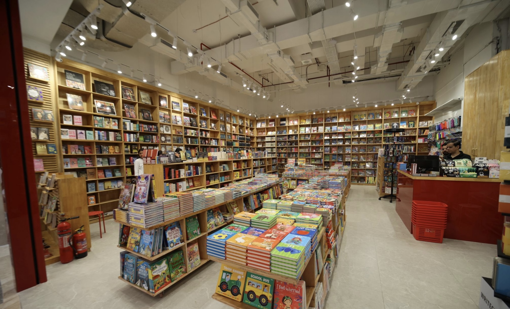 Interior view of bookstore shelving lit by continuous track spotlights