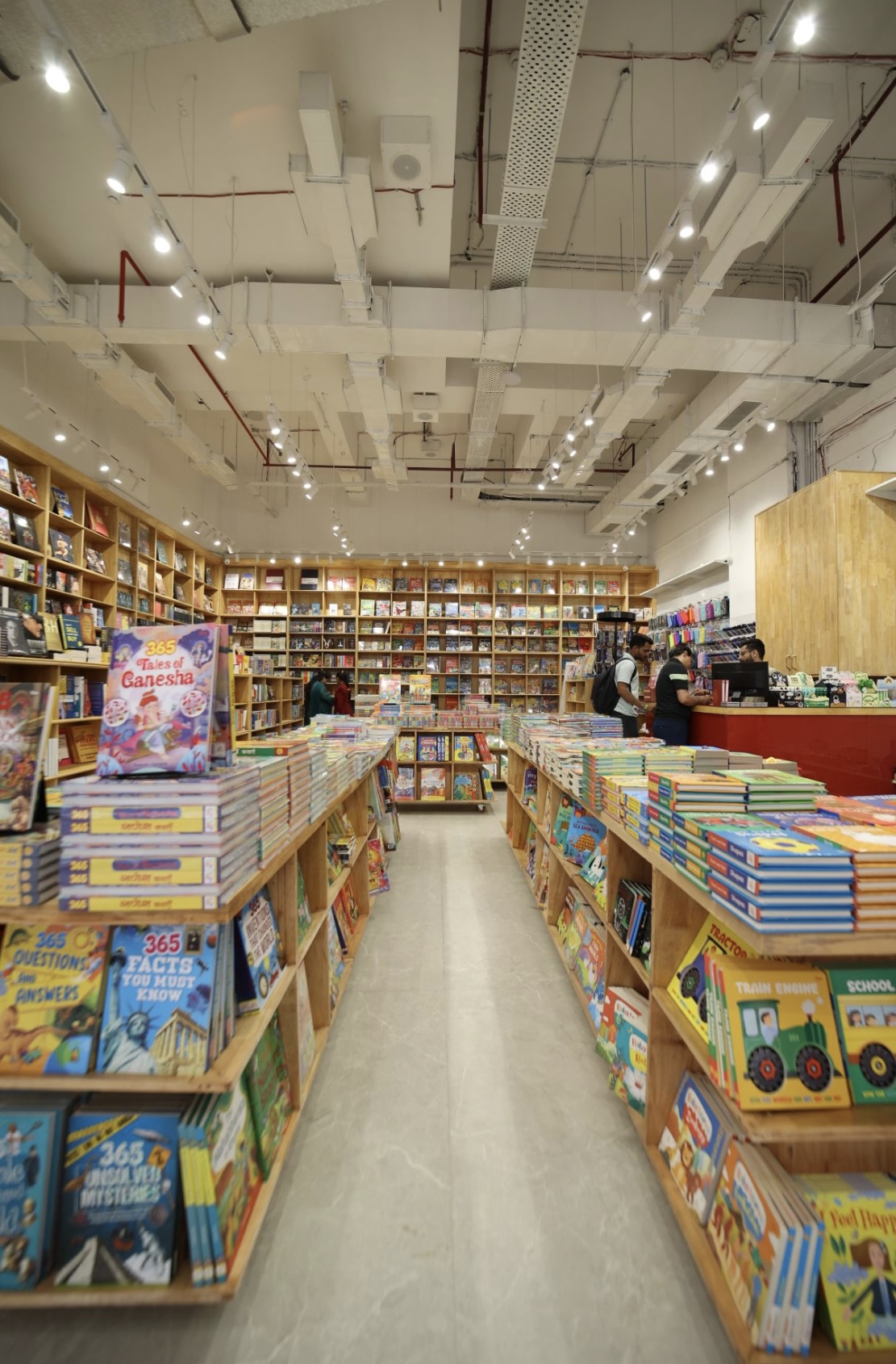 Children's book tables with full-height shelving behind