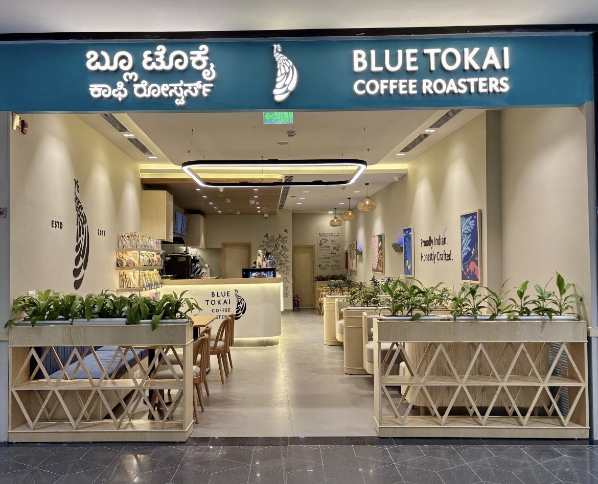 Blue Tokai Coffee Roasters storefront with teal signage in Kannada and English