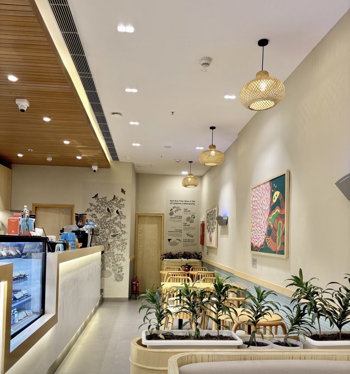 Seating corridor with rattan pendant fixtures over booths